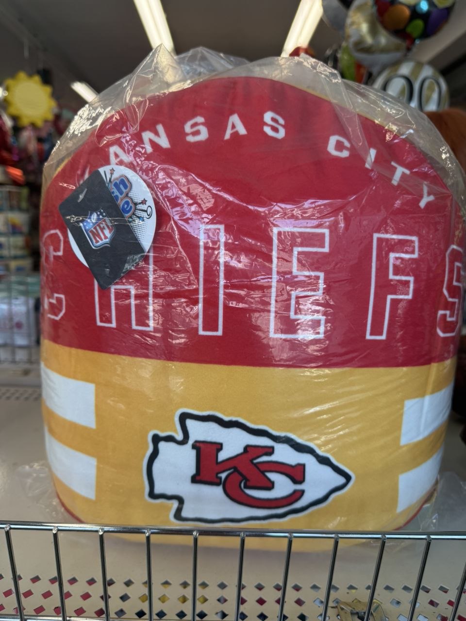 Red and gold Kansas City Chiefs football chair cover on display.