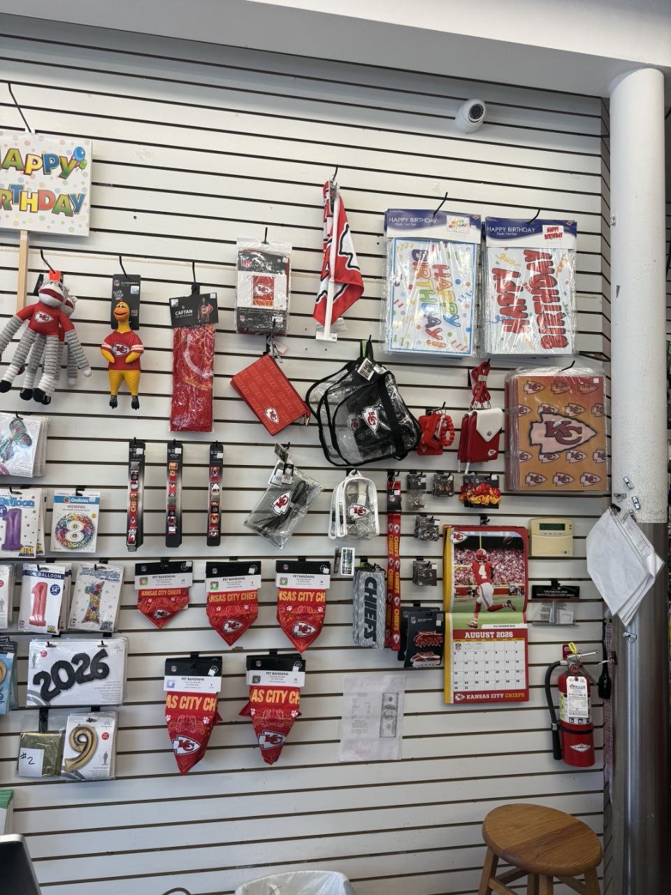 Wall of Kansas City Chiefs bandanas, bags, calendars, and fan accessories.