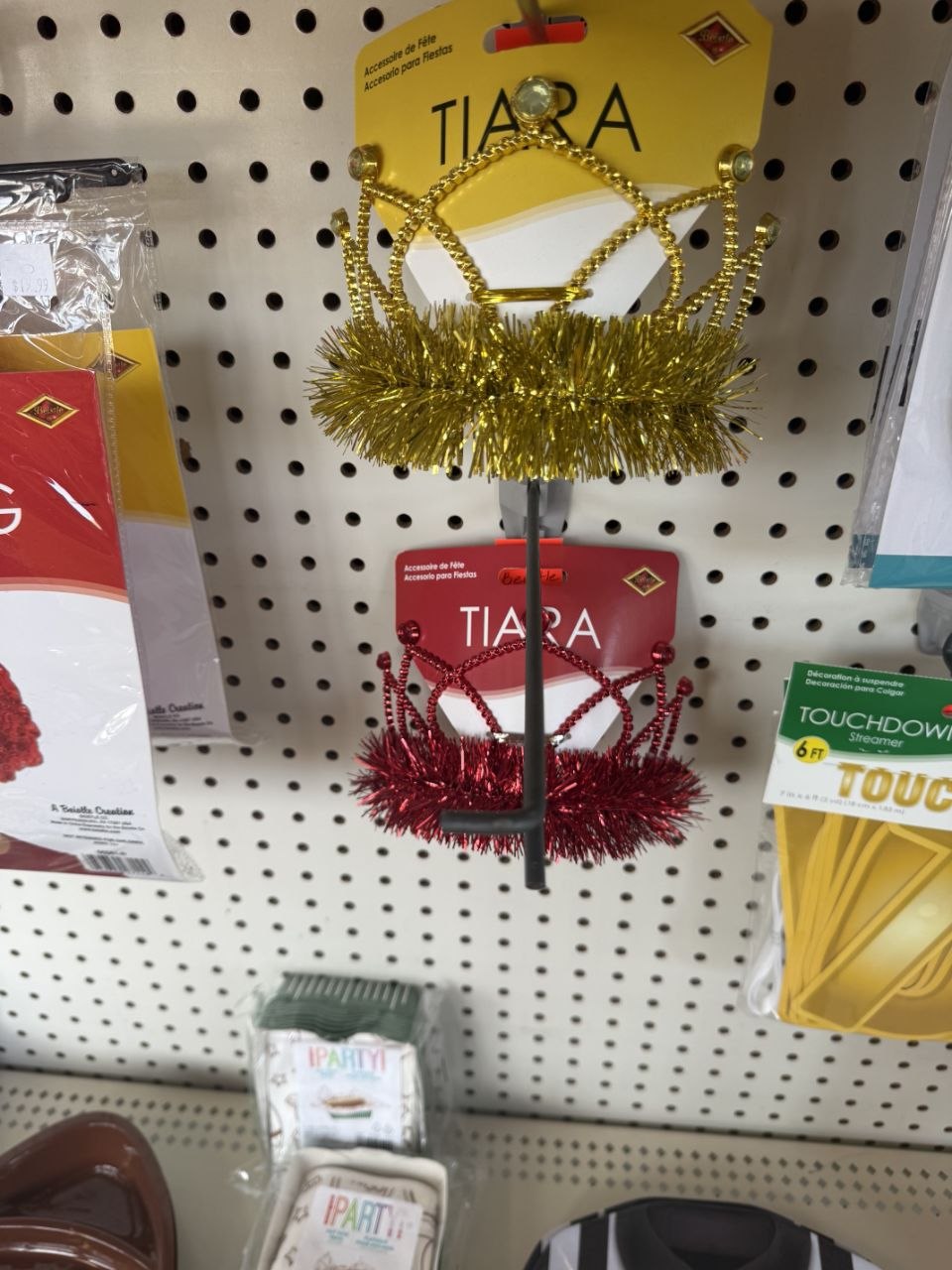 Gold and red football tiara headbands on a party supply display.