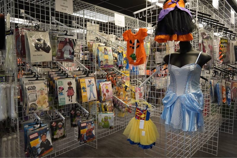 Rows of Halloween costumes, wigs, and accessories in the upstairs section.